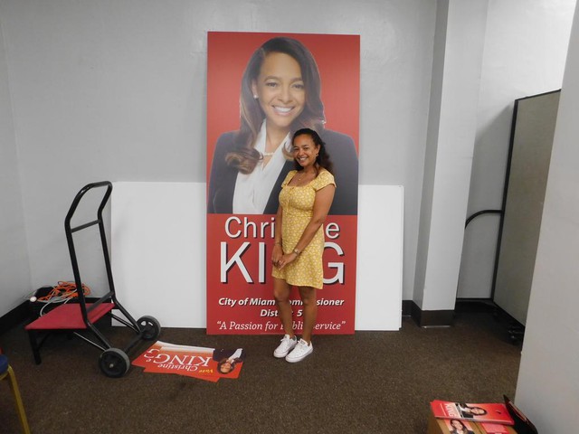 Christine King by a poster.JPG