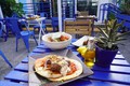 Merake Greek Bistro patio shot with food.jpeg