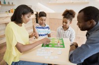 Envato Elements_____african-american-family-playing-board-game-in-cafe-2022-12-16-20-22-36-utc.jpg