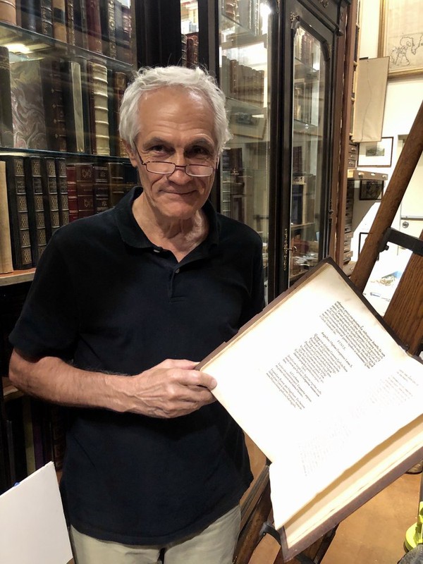 Book store owner sharing an old and rare book.jpg
